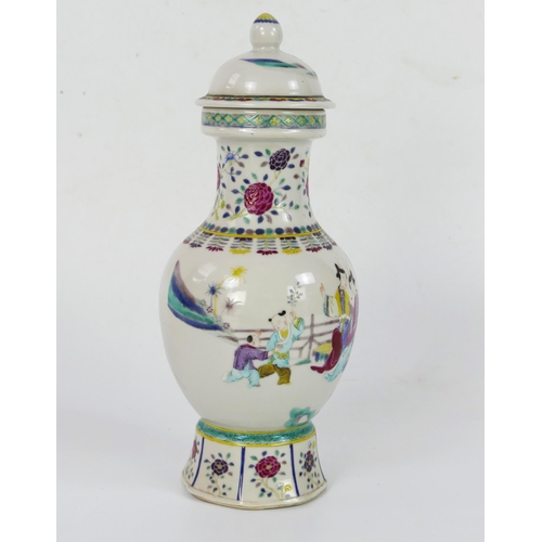 1697 - A Chinese famille rose vase and cover, of baluster form decorated in enamels depicting figures in a ... 