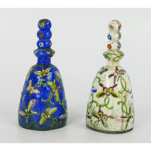 1699 - Two Chinese enamelled call bells, decorated with butterflies amongst foliage, each with knopped hand... 