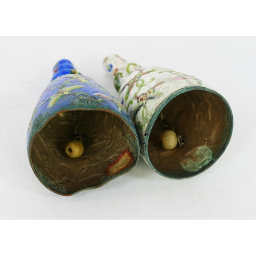 1699 - Two Chinese enamelled call bells, decorated with butterflies amongst foliage, each with knopped hand... 