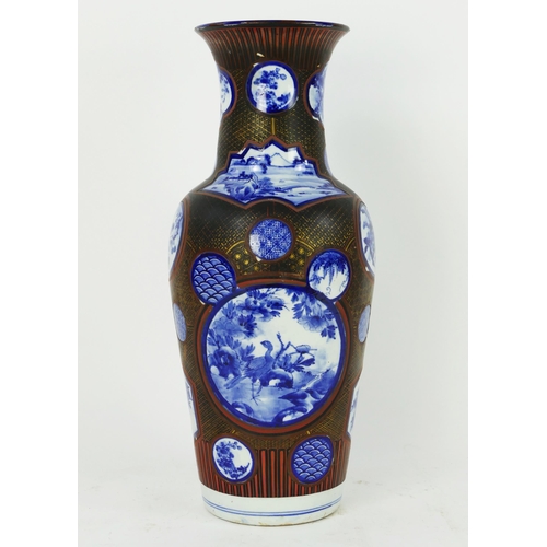 1700 - A large Japanese blue and white vase of baluster form, the circular panels enclosed with a lacquered... 