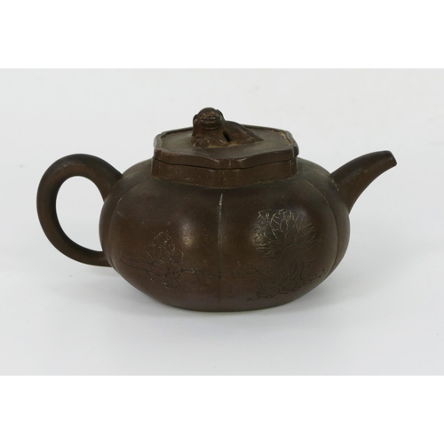 1701 - A Chinese Yixing pottery teapot and cover, of lobed circular form, with dog of Fo finial, 18cm long.