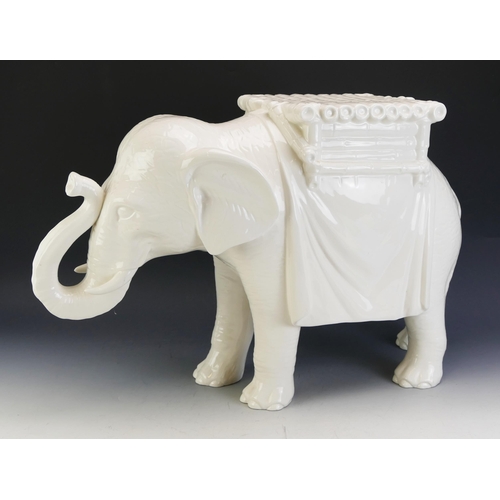 1705 - A large white pottery jardiniere stand modelled as an elephant, 64cm long, 40cm high.