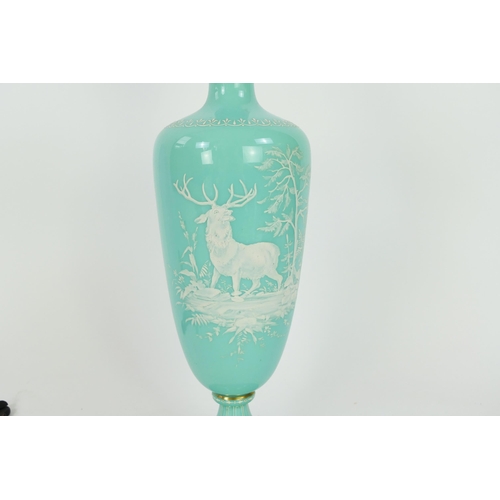 1716 - A Victorian pale green glass vase, of ovoid form with flared neck with white overlay decoration of a... 