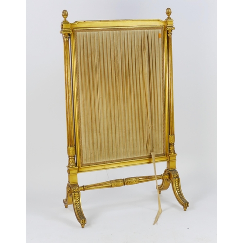 1722 - A gilt wood firescreen of rectangular outline, with silk work panel within fluted columns with pinea... 