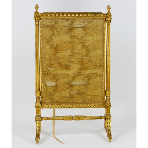 1722 - A gilt wood firescreen of rectangular outline, with silk work panel within fluted columns with pinea... 