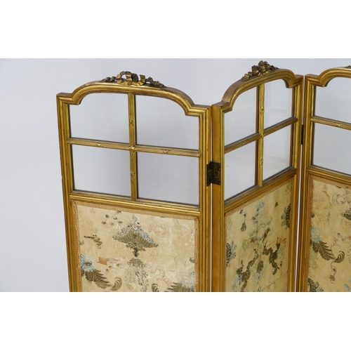 1723 - A gilt wood triple panel folding screen, of arched outline with ribbon tied decoration, with silk pa... 