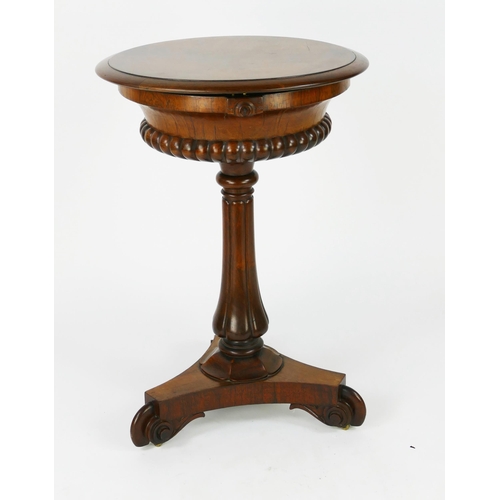 1727 - A 19th century rosewood teapoy, the circular top with hinged lid enclosing two lidded caddies and tw... 