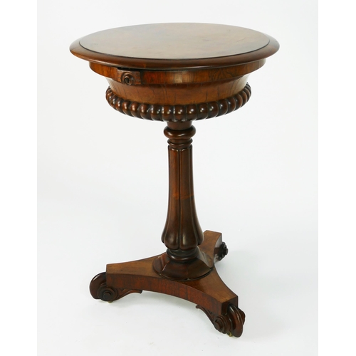 1727 - A 19th century rosewood teapoy, the circular top with hinged lid enclosing two lidded caddies and tw... 