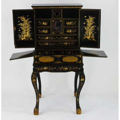 1728 - A late 19th century Chinese export lacquered writing desk, decorated all over with figures in pagoda... 