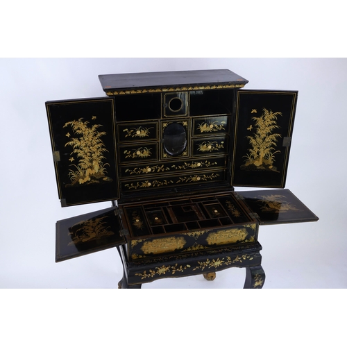 1728 - A late 19th century Chinese export lacquered writing desk, decorated all over with figures in pagoda... 