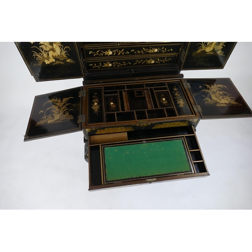 1728 - A late 19th century Chinese export lacquered writing desk, decorated all over with figures in pagoda... 