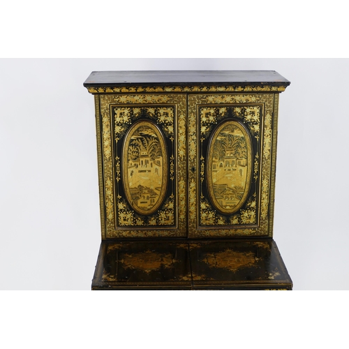 1728 - A late 19th century Chinese export lacquered writing desk, decorated all over with figures in pagoda... 