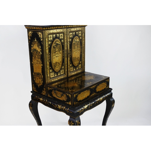 1728 - A late 19th century Chinese export lacquered writing desk, decorated all over with figures in pagoda... 