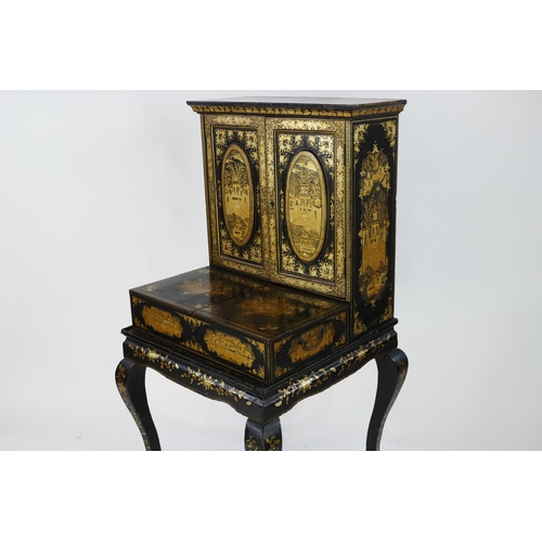 1728 - A late 19th century Chinese export lacquered writing desk, decorated all over with figures in pagoda... 