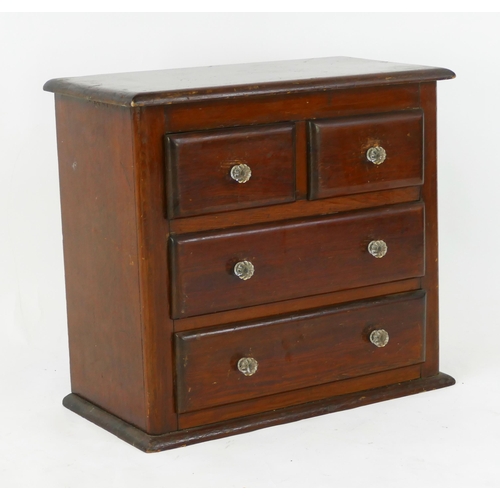 1729 - A stained beech table top chest containing two short and two long drawers, on a plinth base, W. 51cm... 