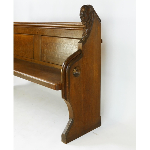 1730 - A Victorian oak church pew, the scroll ends with carved foliate decoration, and solid seat, W. 150, ... 