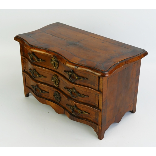 1488 - A George III period French walnut miniature chest, of serpentine outline, with crossbanded top conta... 