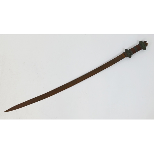 1621 - An African sword, with 83cm curved and fullered blade, having wood and wire bound grip and oval pomm... 