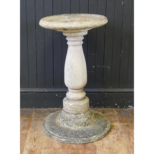 1654 - A reconstituted stone bird bath, the circular dish raised on a knopped and tapering column, mounted ... 