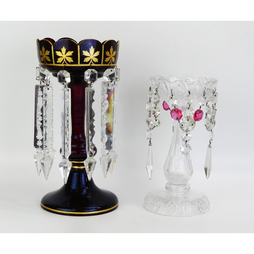 1720 - A Victorian ruby glass and gilt decorated lustre, 32cm high together with a clear glass example, 26c... 