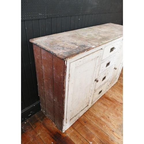 1731 - A painted pine dresser base, with rectangular top, containing four graduated drawers flanked by cupb... 