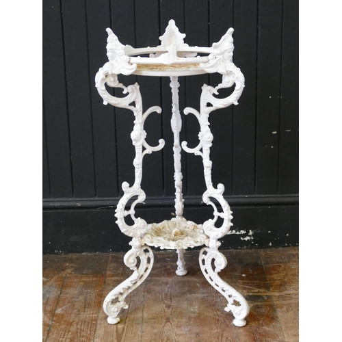 1734 - A Victorian cast iron and painted two tier plant stand, on three scroll and foliate decorated suppor... 