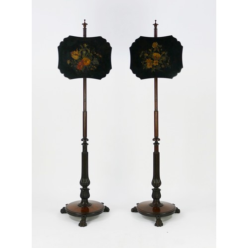 1499 - A pair of William IV rosewood pole screens, with cartouche-shaped and floral decorated screens, on t... 