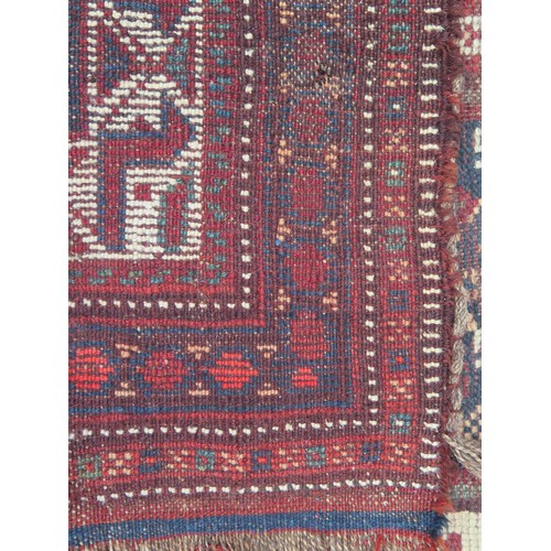 1740 - A Caucasian rug, the indigo field with three rows of stepped lozenge medallions enclosed by a multip... 