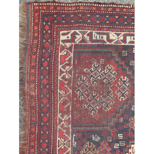 1740 - A Caucasian rug, the indigo field with three rows of stepped lozenge medallions enclosed by a multip... 