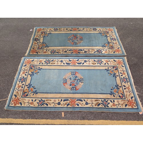 1738 - A Chinese rug, the powder blue field with central mons, enclosed by a floral meander border, 180 x 9... 