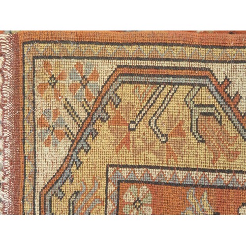 1739 - A Persian design runner, the rust field, with single row of lozenge medallions, enclosed by a double... 