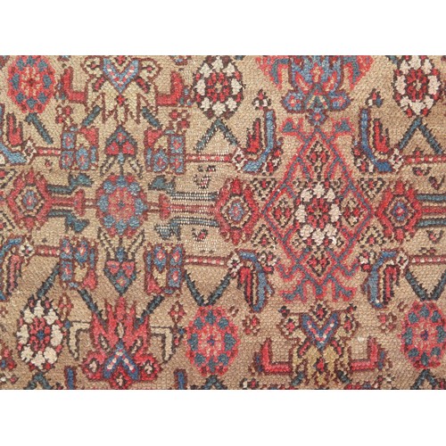 1737 - A Persian design runner, the beige field with rows of lozenge medallions and flowerheads, enclosed b... 