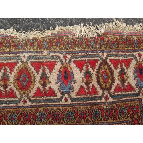 1737 - A Persian design runner, the beige field with rows of lozenge medallions and flowerheads, enclosed b... 