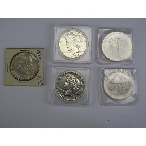 116 - A USA 1886 Morgan Dollar, 1923 Peace Dollar, 1934 Peace Dollar and two 2006 1oz fine silver dollars