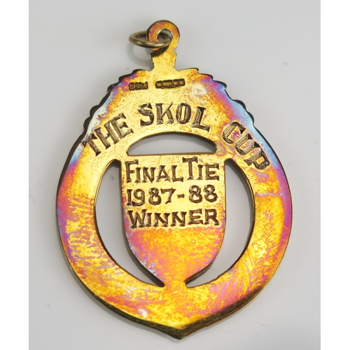 29 - A Scottish Football League The Skol Cup 987-88 9ct gold and enamel winners medal 8.62gms, contained ... 