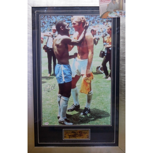 72 - A framed and glazed picture of Pele and Bobby Moore swapping shirts during Mexico ‘70 signed by Pele... 