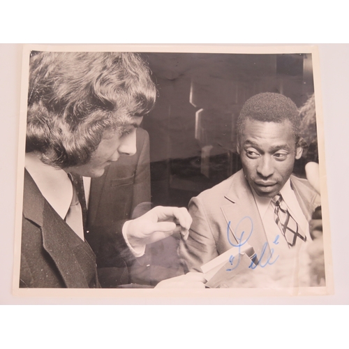 73 - A black and white photograph of Trevor Francis with Pele, signed by Pele
*SOLD WITH A LETTER OF CONF... 