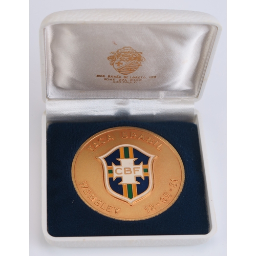 94 - A gilt metal and enamel commemorative medallion England V Brazil, Wembley 12-05-81, with CBF enamel ... 