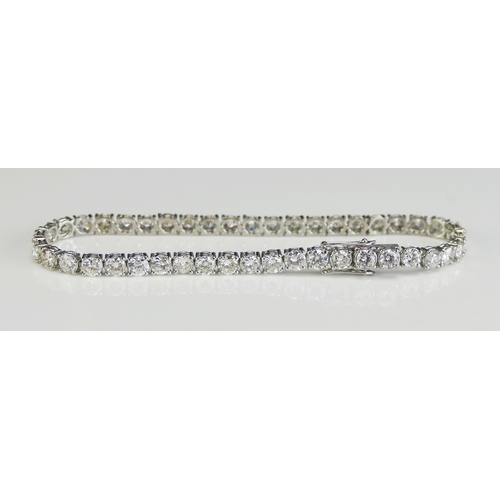 1 - A Platinum and Diamond Tennis or Line Bracelet set with 34 c. 3.t6mm brilliant round cuts weighing c... 