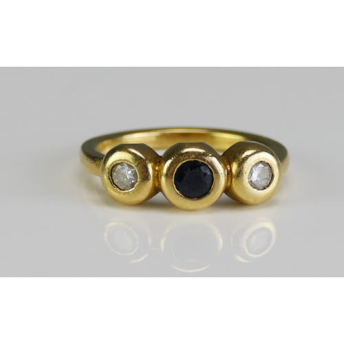 10 - An 18ct Gold, Sapphire and Diamond Three Stone Ring of contemporary rub over setting, c. 3.7mm centr... 