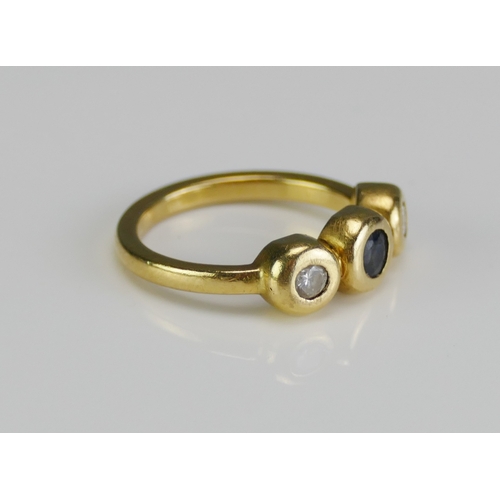 10 - An 18ct Gold, Sapphire and Diamond Three Stone Ring of contemporary rub over setting, c. 3.7mm centr... 