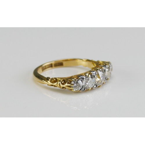 136 - An 18ct Gold and Diamond Five Stone Ring, c. 5.4mm principal brilliant round cut with 4.6 and 3.5mm ... 