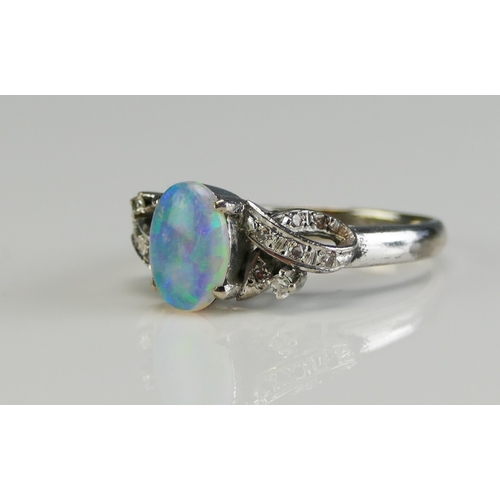 149 - A 14K White Gold, Opal and Diamond Ring, 8.77x6.3mm principal stone, size L, stamped 14K, 3.63g