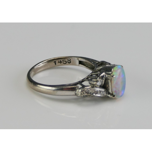 149 - A 14K White Gold, Opal and Diamond Ring, 8.77x6.3mm principal stone, size L, stamped 14K, 3.63g