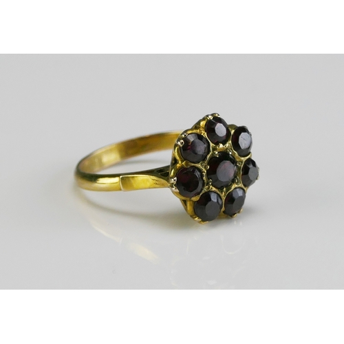 155 - A 9ct Gold and Garnet Cluster Ring, 13mm head, size L.25, stamped 9CT, 3.11g