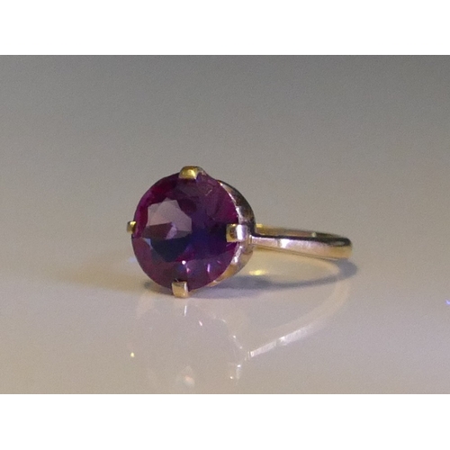 158 - An Alexandrite? Colour Change Gem Set Ring in a high carat precious yellow metal setting, 10.8mm sto... 