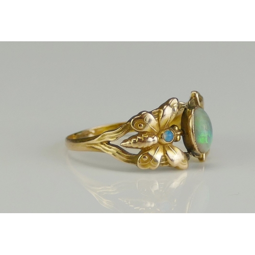 192 - An Opal 'Butterfly' Ring in a high carat precious yellow metal setting, size O. 2.11g. One stone mis... 