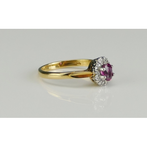 204 - An 18ct Gold Ruby and Diamond Cluster Ring, c. 4.9x3.7mm principal stone, 8.3x7.1mm head, size L.5, ... 