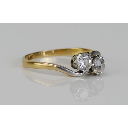 213 - An 18ct Gold and Diamond Platinum Set Crossover Ring, c. 4.75mm stones, size M.5, 2.44g