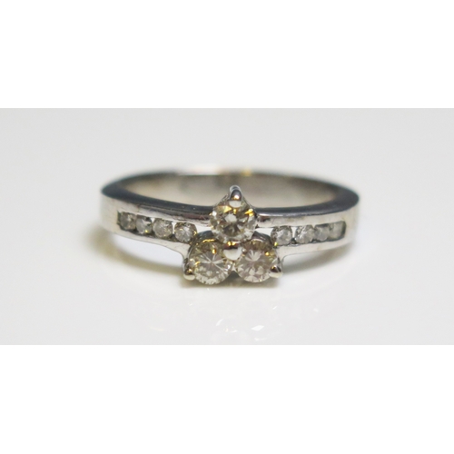 298 - A platinum three stone diamond ring, with diamond set shoulders, 3.7gms, size K.5/L.